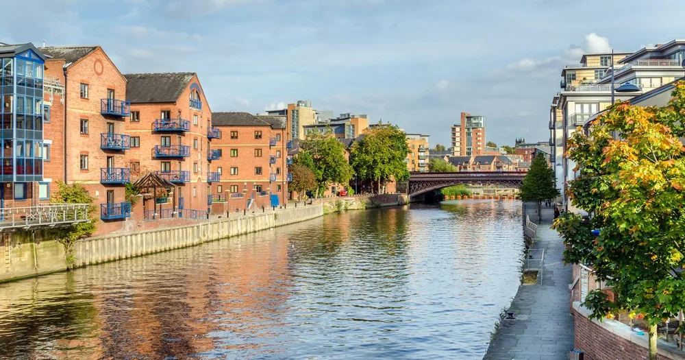 River Aire in Leeds lined with brick apartment buildings