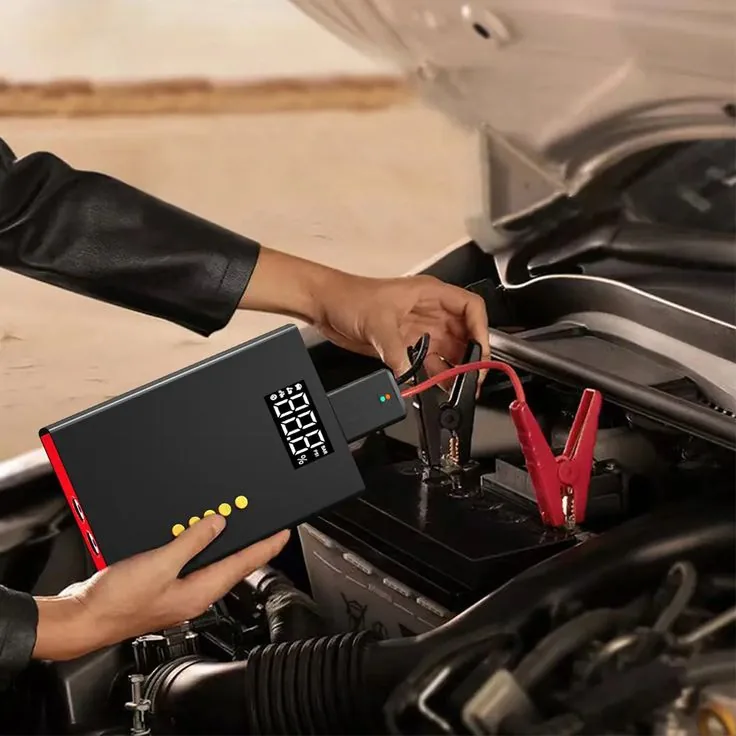 Portable jump starter connected to a car battery